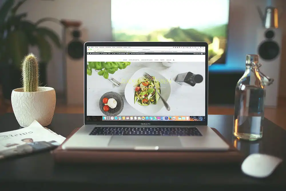 A laptop showing a basic landing page for a food website.